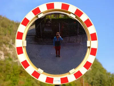 Self-portrait in a round traffic mirror
