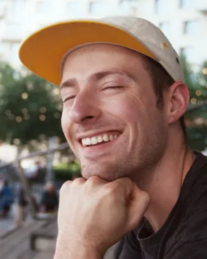 Bryce in a white cap with a yellow brim